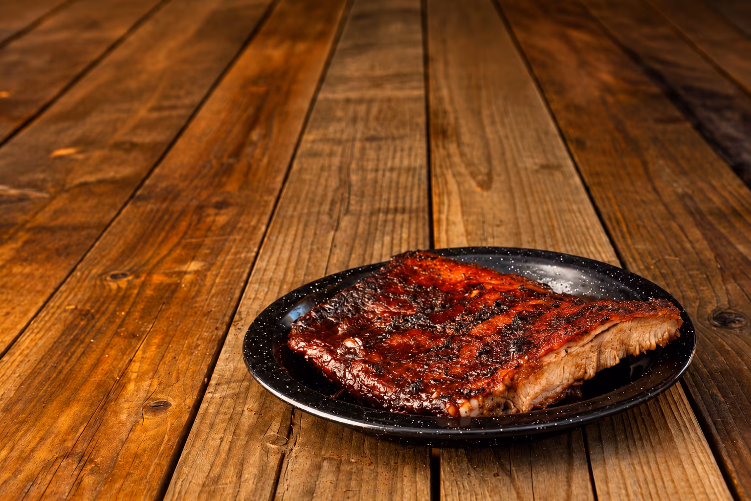 Half rack of smoked pork ribs on a cutting board