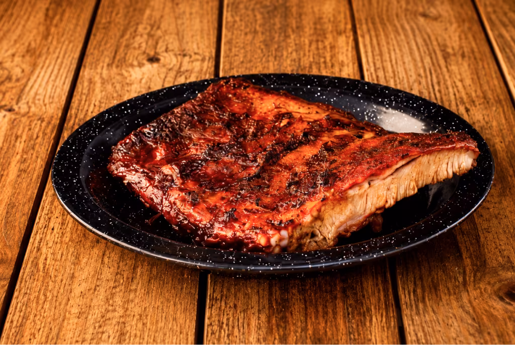 Half rack of smoked ribs on a plate